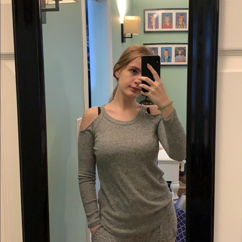 A grey long sleeve shirt with open shoulders